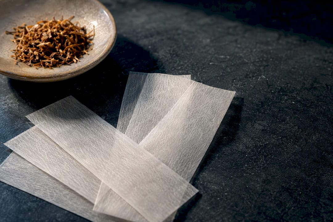 Unbranded rolling papers beside loose tobacco
